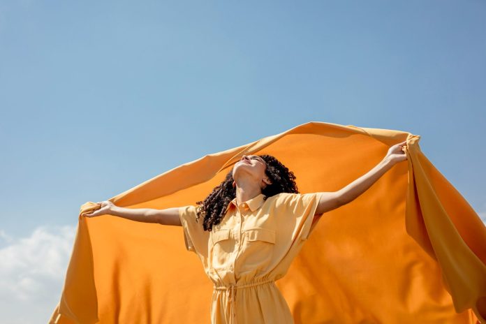 portrait-joyful-woman-with-yellow-cloth-nature